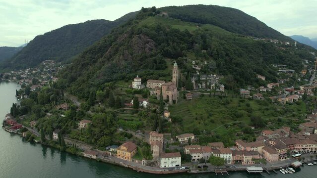 Aerial footage of the parish church Madonna del Sasso stands on the high hill of Vico Morcote. Morcote at the Lake Lugano was once credited as one of the most beautiful Swiss villages