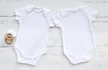 Baby bodysuit front and back template on white wooden background.