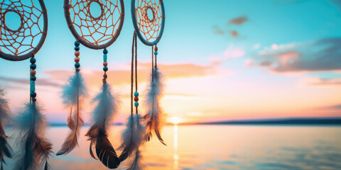 Handmade dream catcher with feathers threads and beads rope hanging on the beach