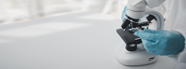 Lab practitioner working on chemical research for chemical reactions, does a chemical experiment and examines a patient's blood sample. Medicine and research concept.