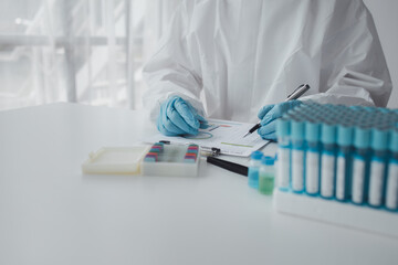 Lab practitioner working on chemical research for chemical reactions, does a chemical experiment and examines a patient's blood sample. Medicine and research concept.