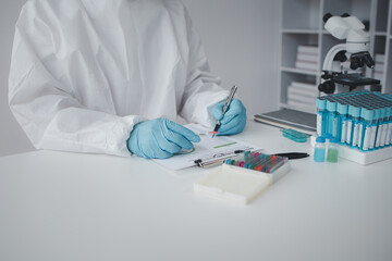 Lab practitioner working on chemical research for chemical reactions, does a chemical experiment and examines a patient's blood sample. Medicine and research concept.