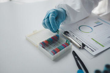 Lab practitioner working on chemical research for chemical reactions, does a chemical experiment and examines a patient's blood sample. Medicine and research concept.