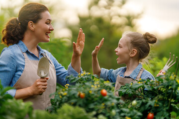 mother and daughter gardening in the backyard