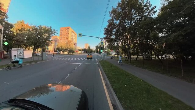 360 degree camera shooting while driving a car on a city street. The camera is above the roof of the car.