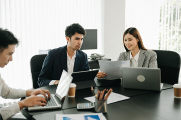  Young Asian business creative team are brainstorming planning discussing while sitting in creative business discussing work in the office.