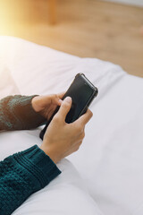 Young adult happy smiling Hispanic Asian student wearing headphones talking on online chat meeting using laptop in university campus or at virtual office. College female student learning remotely.