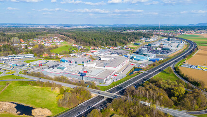 Industrial complex and commercial area beside a highway in Austria seen from the air as example for...