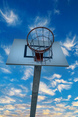High bastkeball hoop with blue sky and clouds