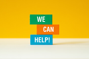 We can help - word concept on building blocks, text