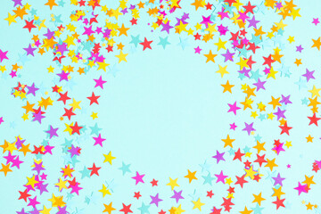 Flat lay top view for circle made of colorful stars on pastel blue background, promotion or...