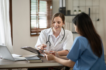 female doctor consulting with a female nurse at the clinic at the hospital