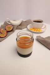 Panna cotta Italian dessert with mango and passion fruit on a light background