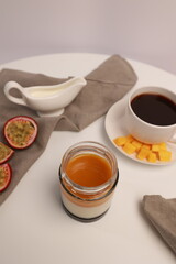 Panna cotta Italian dessert with mango and passion fruit on a light background