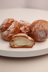 Profiteroles in the section with a view of the natural cream. Profiterole with stuffing