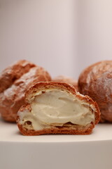Profiteroles in the section with a view of the natural cream. Profiterole with stuffing