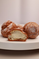 Profiteroles in the section with a view of the natural cream. Profiterole with stuffing