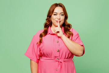 Young secret chubby overweight redhead woman wear casual clothes pink dress say hush be quiet with...