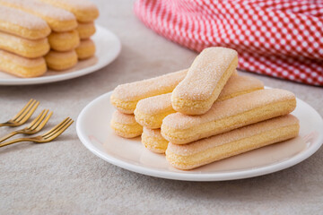 Lady finger biscuits, Italian dessert and sponge cookie on white plate