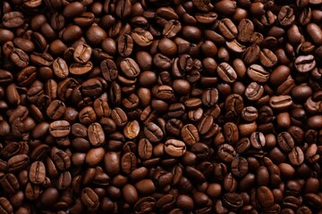 Fresh roasted coffee beans closeup pattern on dark background. Food pattern. Love coffee concept. Top view, flat lay with copy space