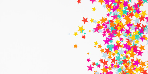 Festive background. Flat lay, top view of colorful  stars, stars on white background. Decoration party, birthday, anniversary, Christmas, New Year celebration concept.