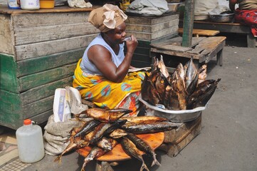 Fish seller waiting for customers at her stall in Makola Market in Accra, Ghana