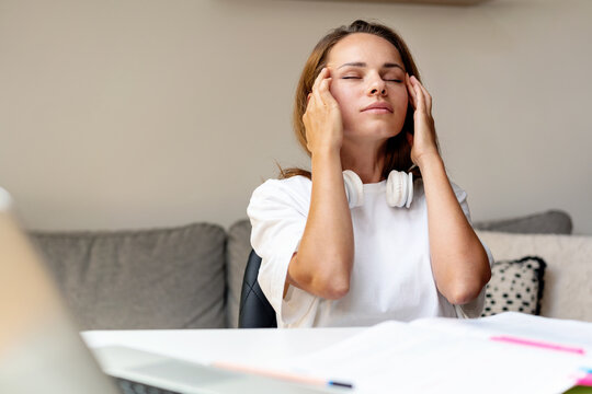 woman having headache, overworked female student, overstudy and overworking concept.
