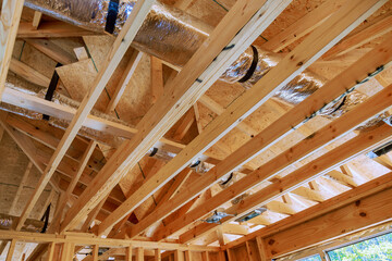 Fototapeta na wymiar Wooden beamed ceiling in new home gains prominence with installation of central HVAC system.