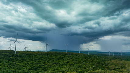 Wind turbine on the brown grass over the mountain the storm