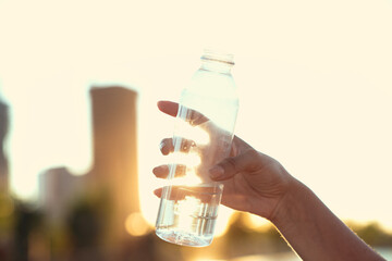 Hand holding bottle of water