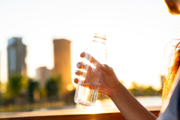 Hand holding bottle of water