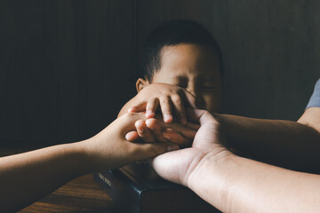 Christian family praying together concept. Child and mother worship God in home. Woman and boy...