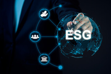 Businessman using stylus pen and virtual screen global with ESG icon concept against dark...