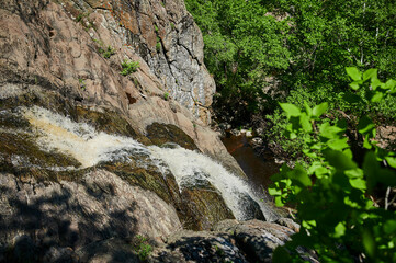 Fototapeta na wymiar Waterfall Gadelsha at springtime, South Urals, Russia.