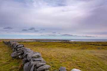 Stone walls along the road and through the fields on Irish island Inishmore, Galway on a beautiful...