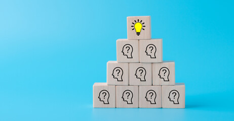 Obraz premium Creative idea and innovation concept with Wooden cubes with icon light bulb and human symbol on blue background.