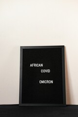Vertical black spongy board with the text "african covid omicron" for background