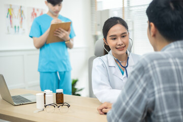 Asian Woman Doctor talking to patient at the clinic or hospital.