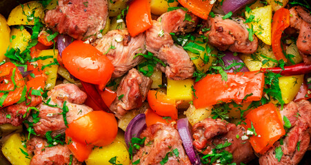 Turkey roast with potatoes, red paprika, onion, parsley, pepper and garlic in cast iron baking...