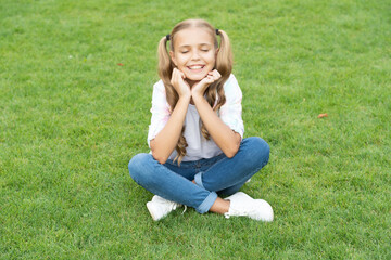relax on summer lawn. girl relax peacefully on the grass. happy childhood of teen girl. summer relax in park. teen girl sitting outdoor. childhood lifestyle of teen. feeling a sense of awe