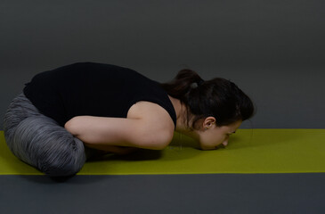 Fototapeta na wymiar Woman doing yoga in photo studio on isolated background.