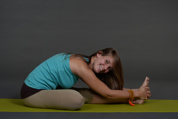 Fototapeta na wymiar Woman doing yoga in photo studio on isolated background. 