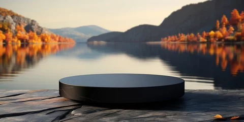 Tuinposter Empty round black podium on stone platform with autumn lake and forest background for product display. © Honey Bear