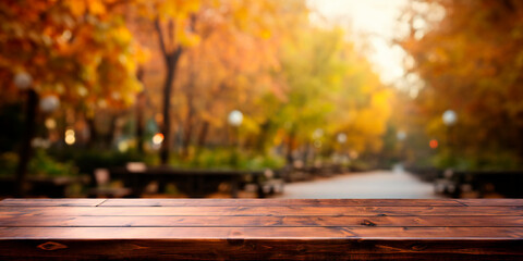 Naklejka na ściany i meble Wooden empty table in front of blurred background of autumn city in cloudy weather.