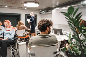 Young multicultural employees brainstorming in a modern office room, exchanging business ideas,...