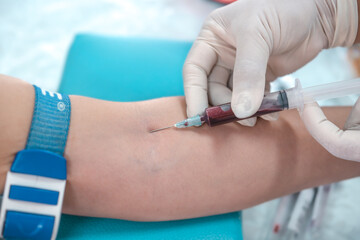 Close up hand of nurse, taking blood sample from a patient in the hospital
