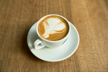 Closeup of a latte macchiato cup on a wooden table