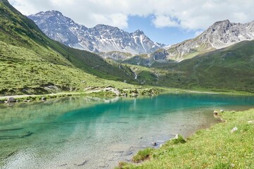 Fototapeta na wymiar Alpine scenery in Arosa, Switzerland featuring a serene lake surrounded by majestic mountains