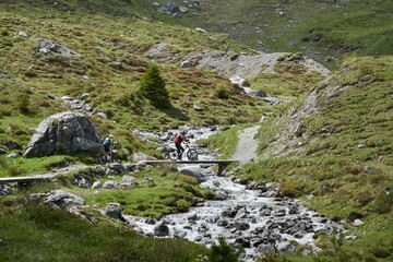 People cycling amidst the majestic mountains of Arosa, Switzerland