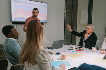 Older business man with his hand up wants to talk